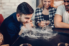 Friends vaping and drinking